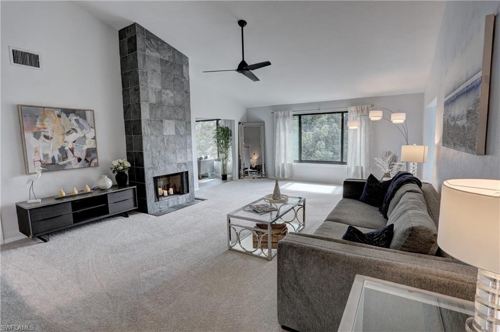 a living room with furniture and a fireplace