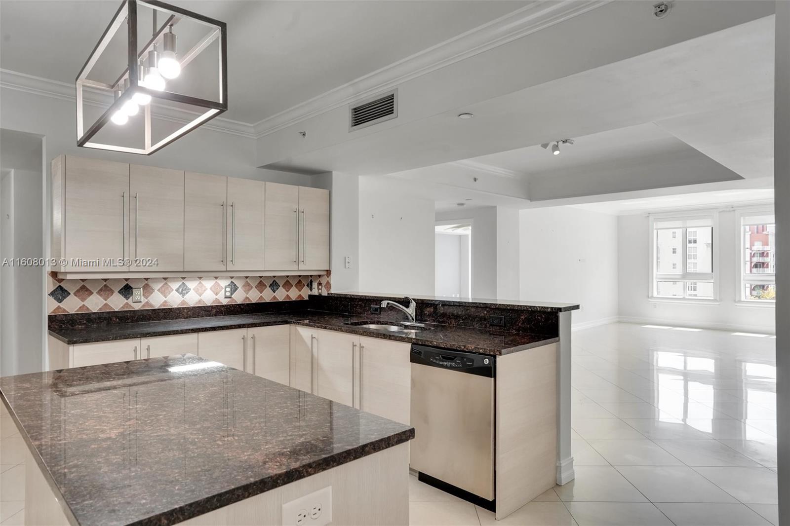 a kitchen with granite countertop a stove a sink and a microwave