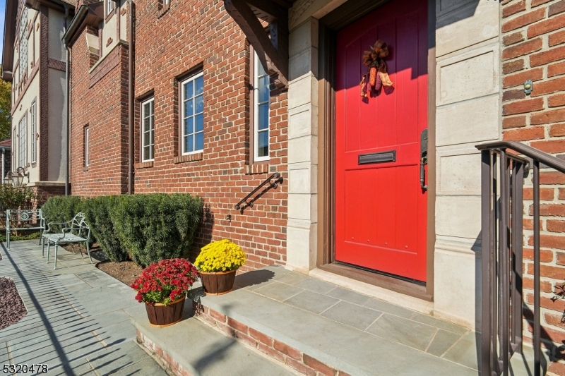 a front view of a house with outdoor seating