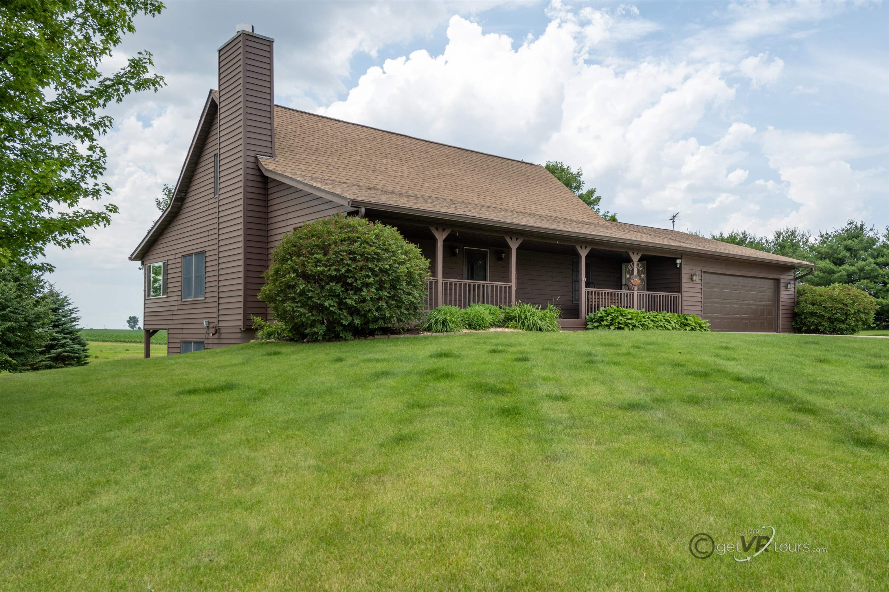 a view of a house with garden and yard