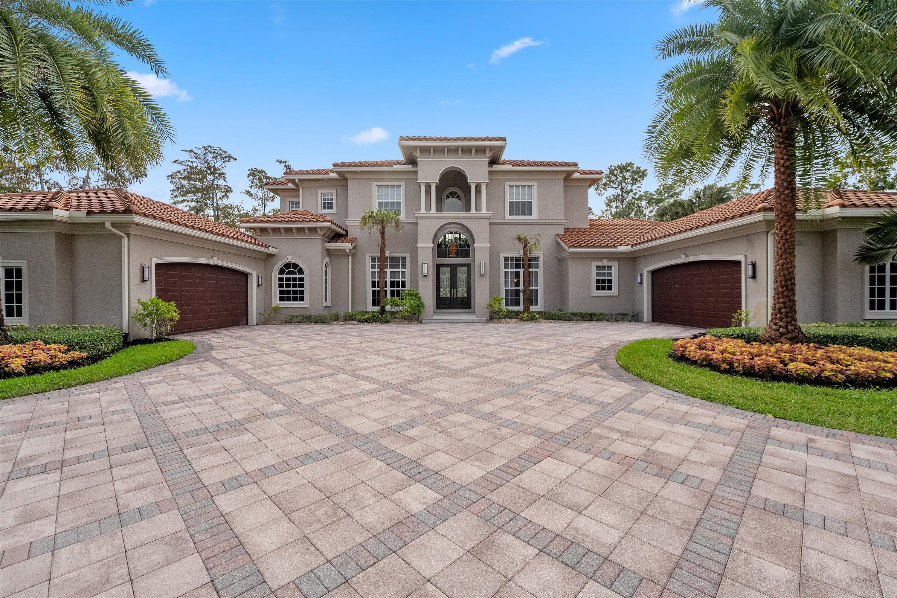 a front view of a house with a garden and yard