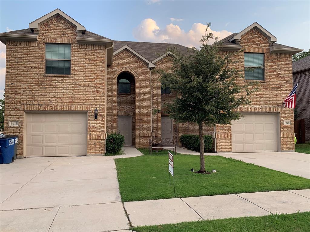 a front view of a house with a garden and yard