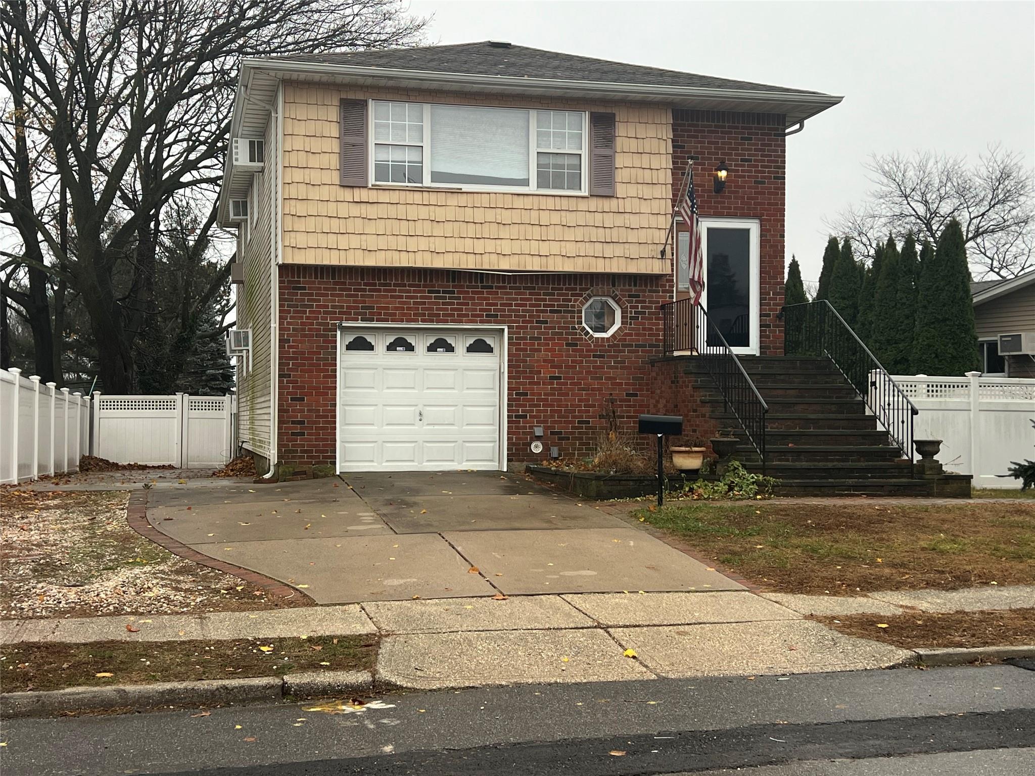 a front view of a house with garage