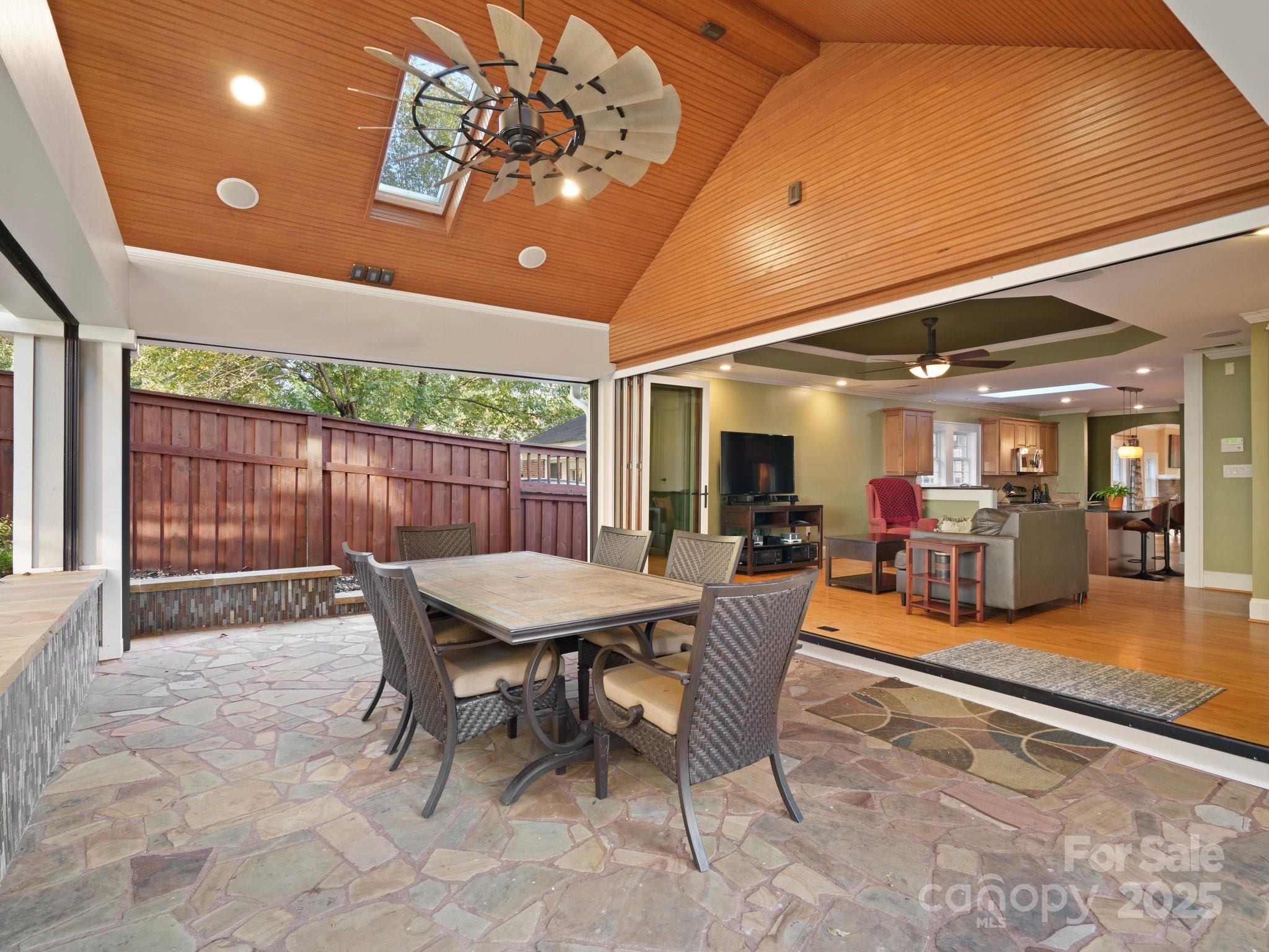 a view of a dining room with furniture wooden floor and chandelier