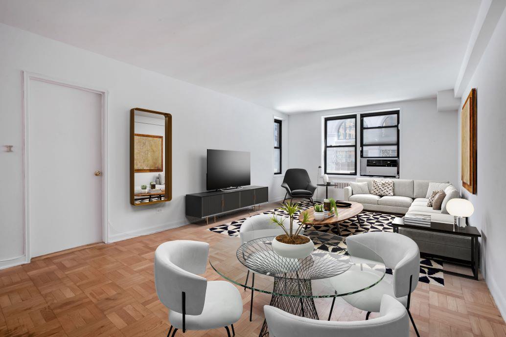 a living room with furniture a flat screen tv and a window