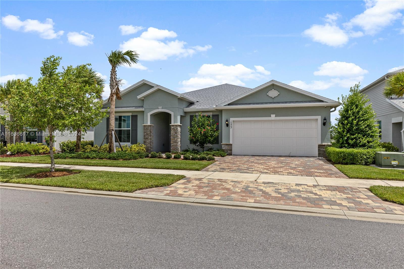 a front view of a house with a yard and garage