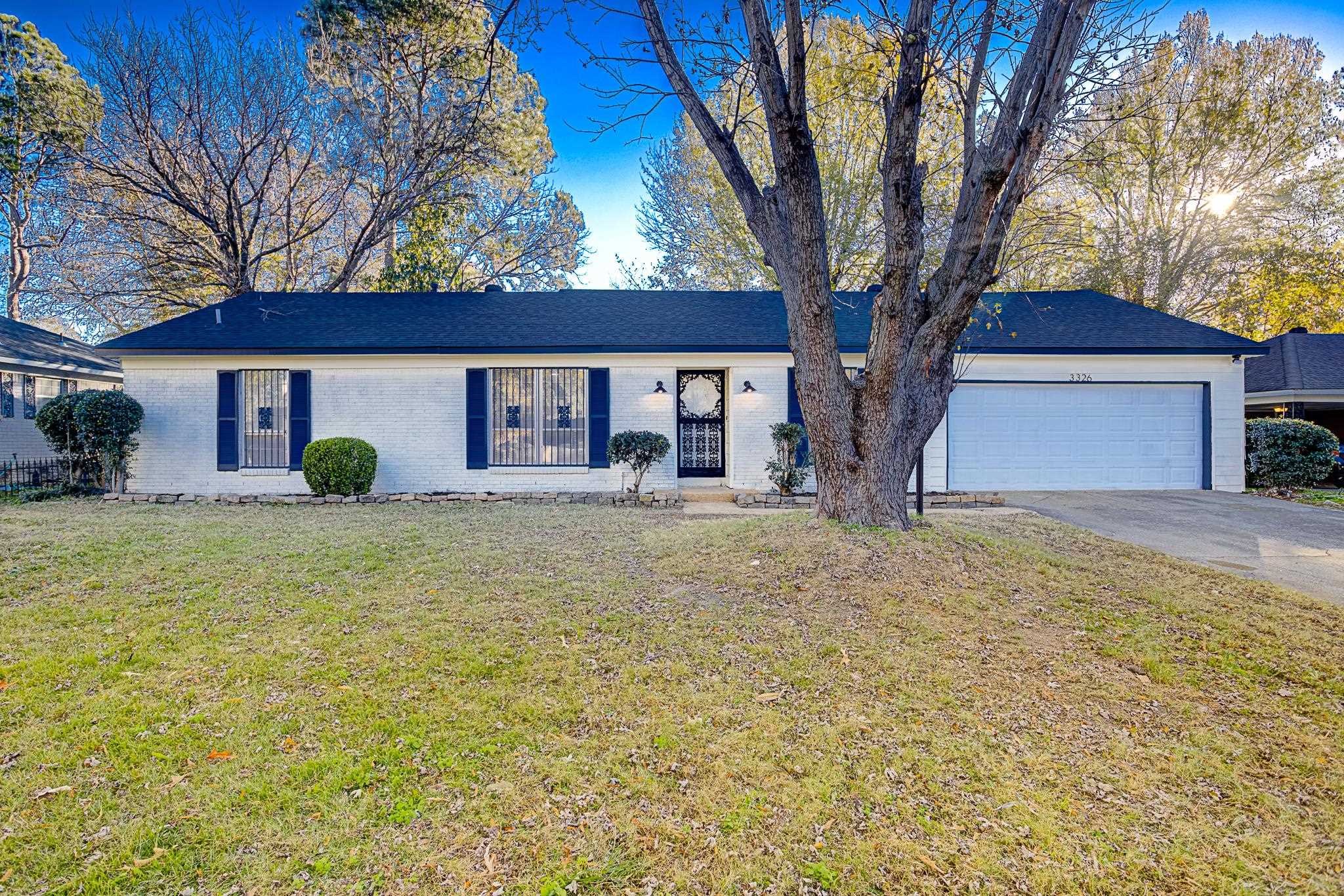 Single story home with a front yard and a garage