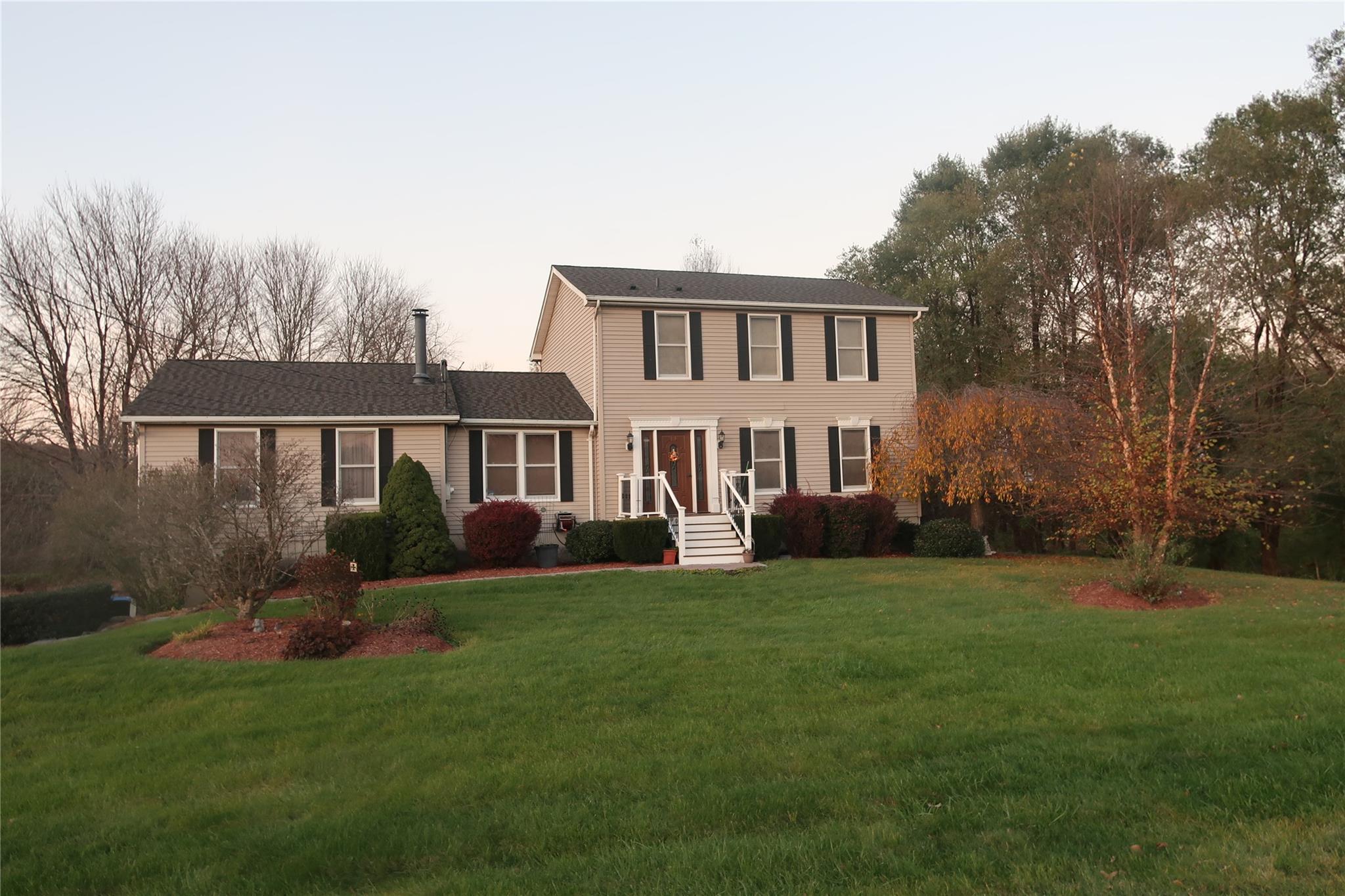 a front view of a house with a garden