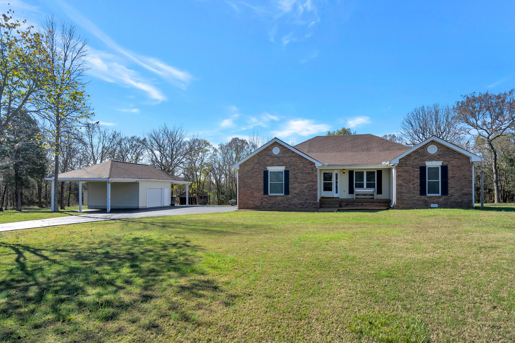 a front view of a house with yard and trees