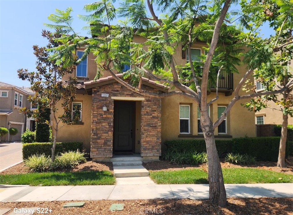 a front view of a house with garden