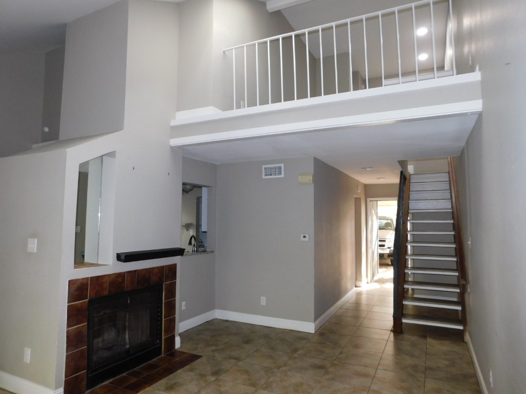 a view of entryway and hall with a fireplace