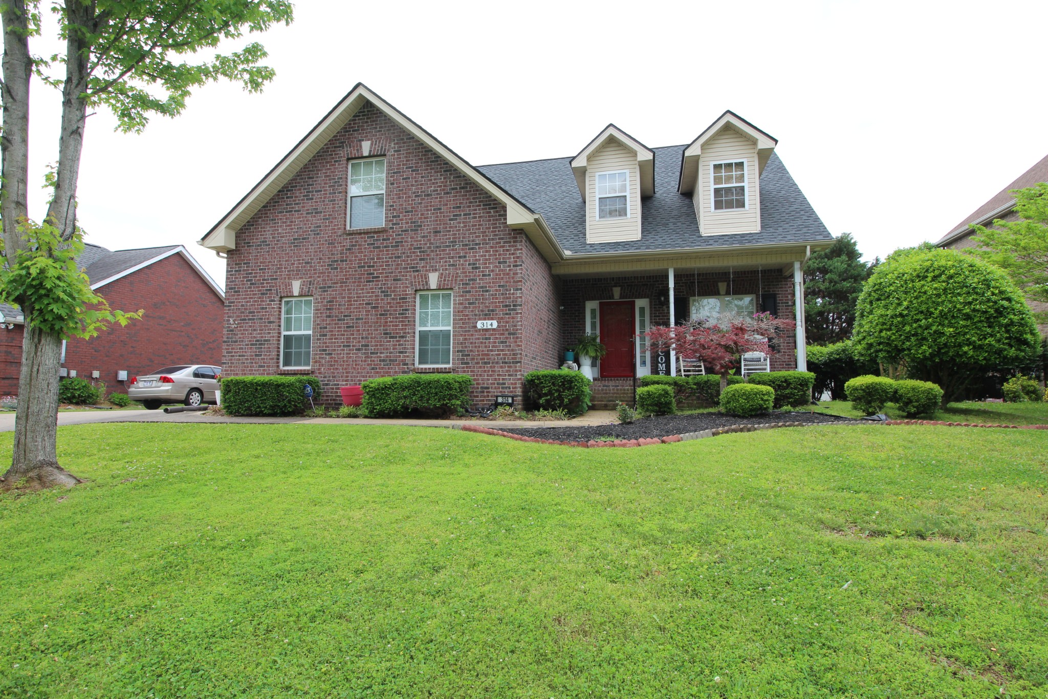 a front view of house with yard and green space