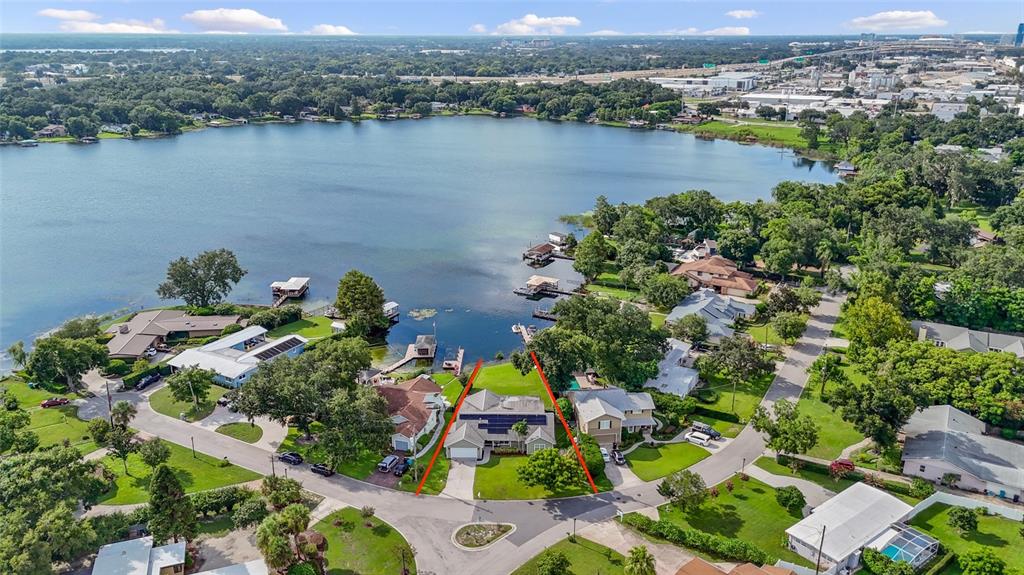 an aerial view of lake and residential houses with outdoor space