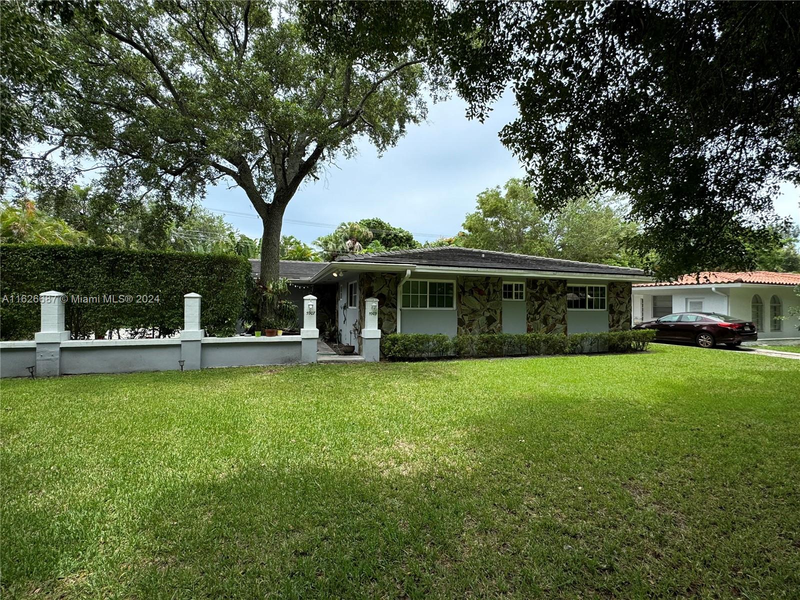 a front view of a house with garden