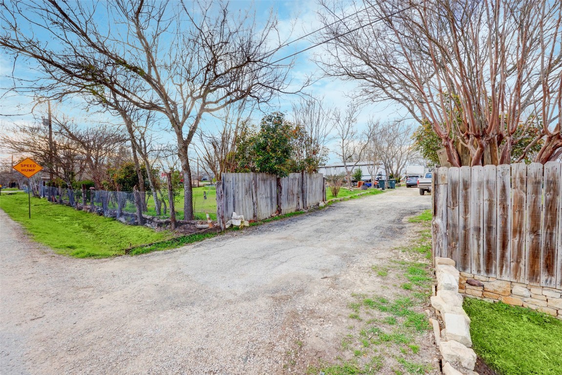 a view of a backyard with wooden fence