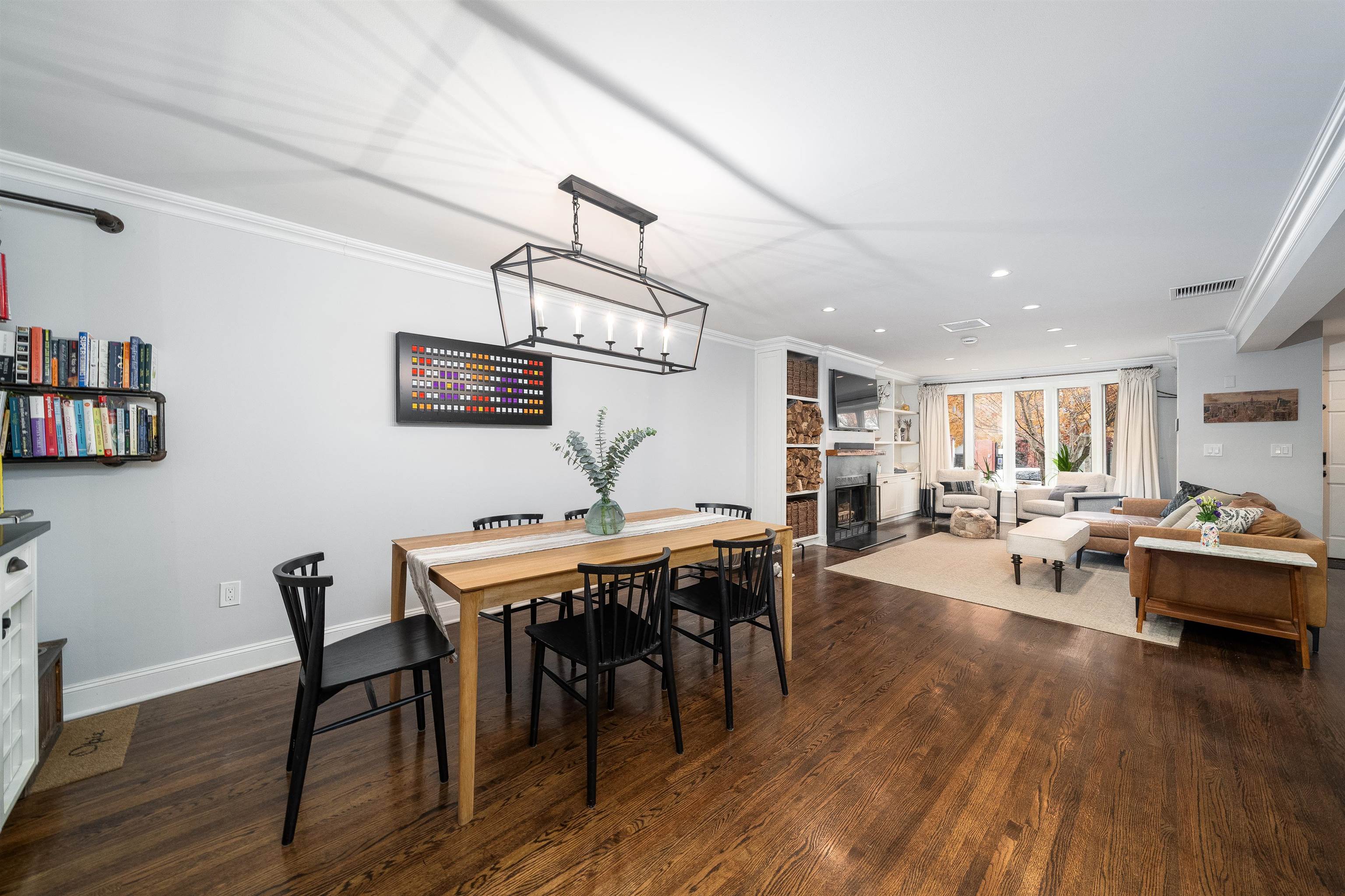 a view of a dining room with furniture wooden floor and chandelier