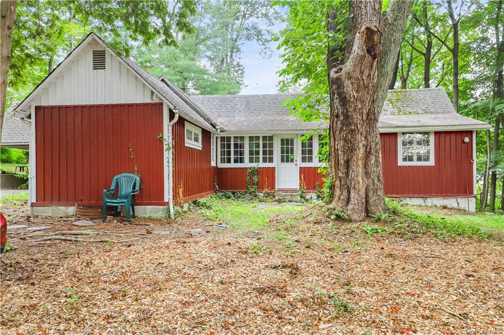 a backyard of a house with barbeque oven and outdoor seating