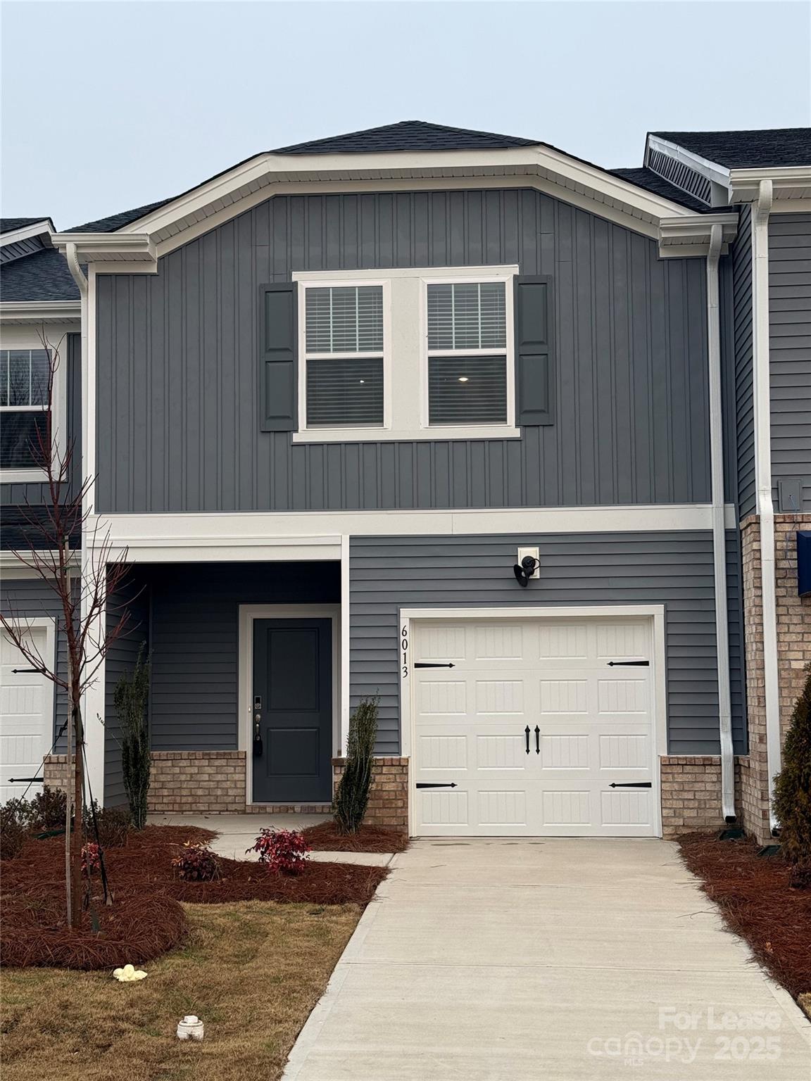 a front view of a house with garage