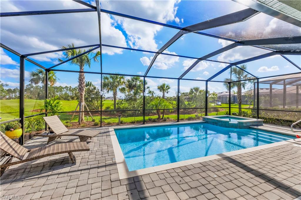 a view of a swimming pool with a lounge chairs