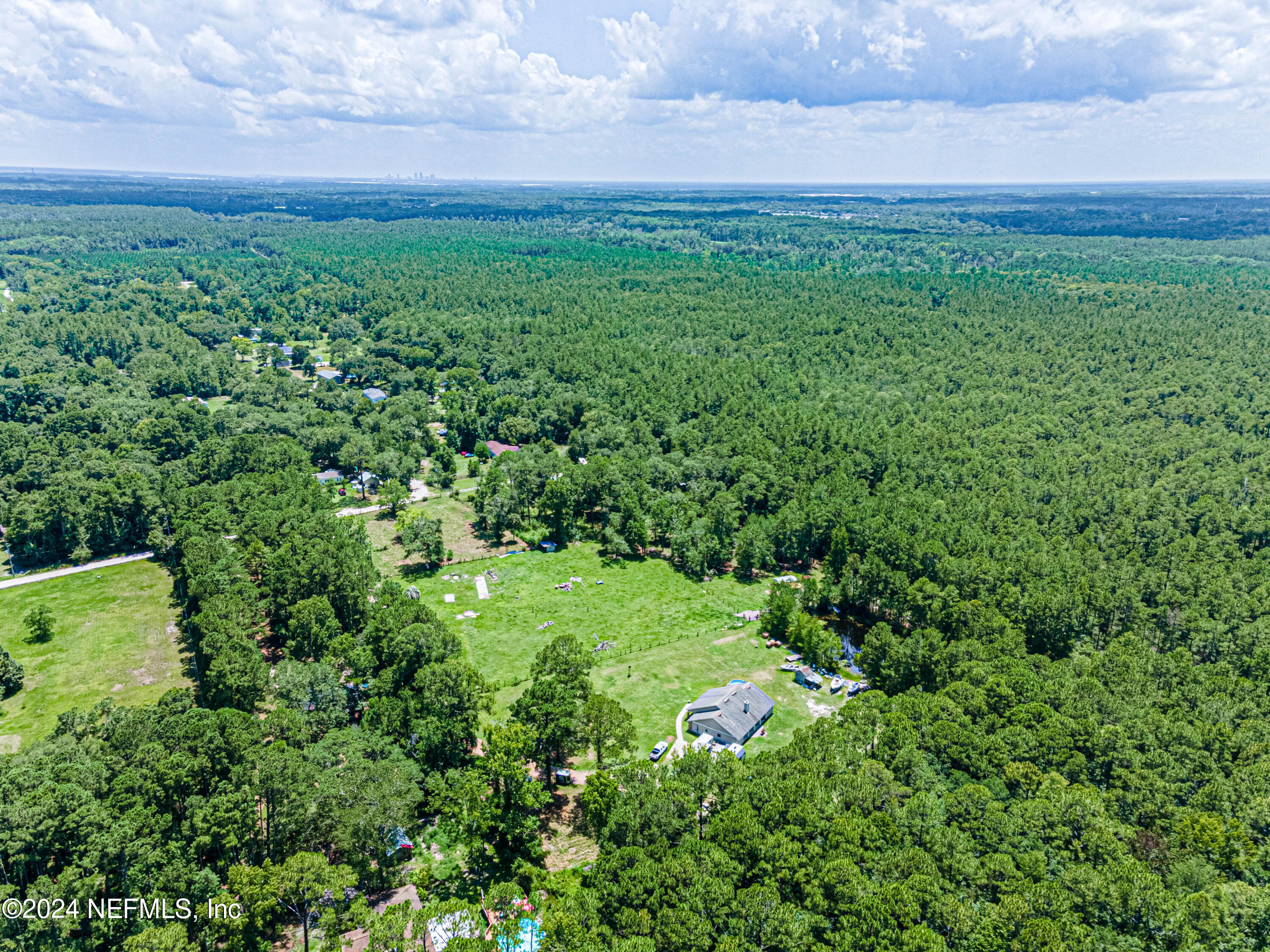 a view of a field of grass and trees