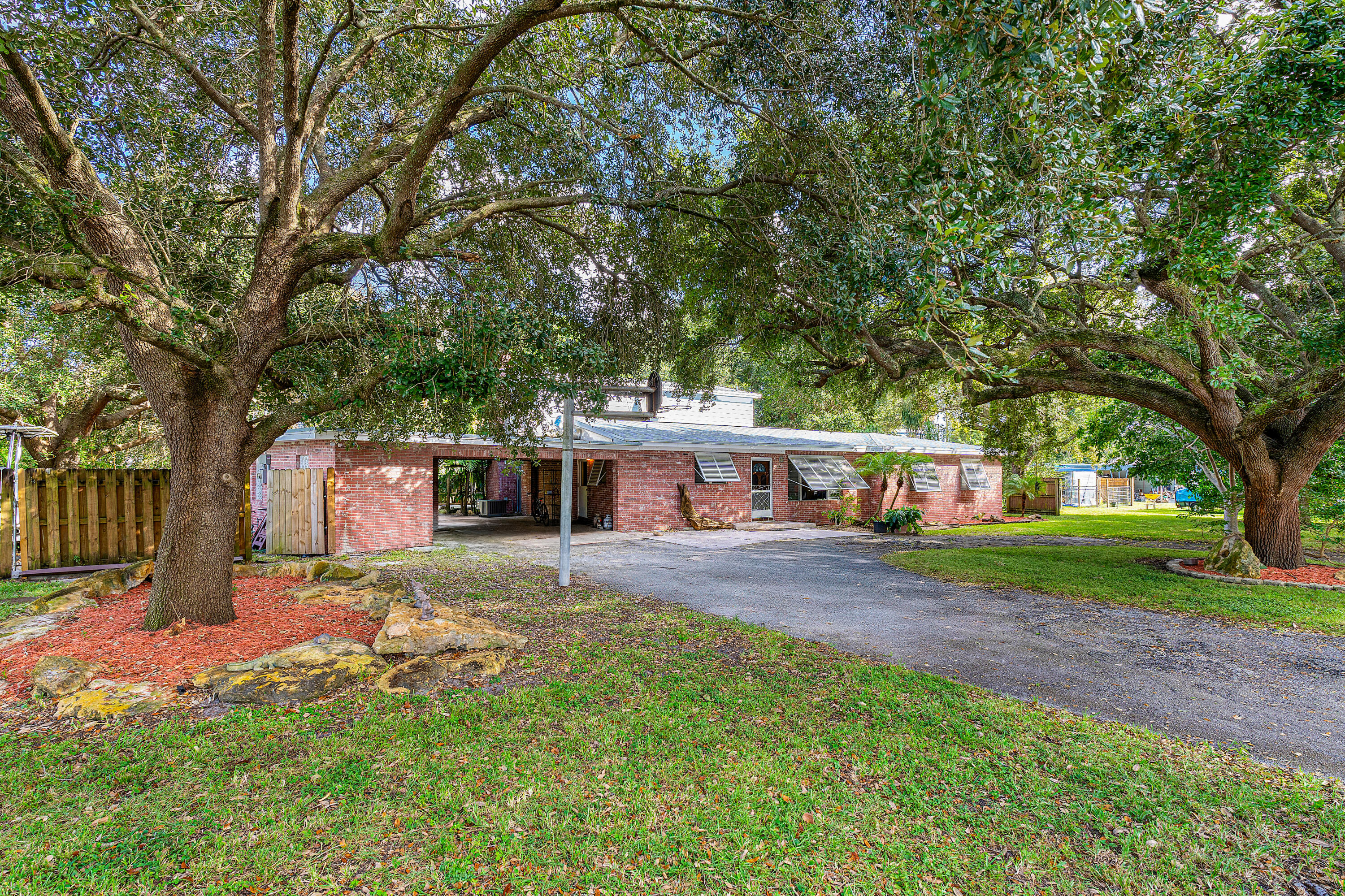 a front view of a house with a yard and trees