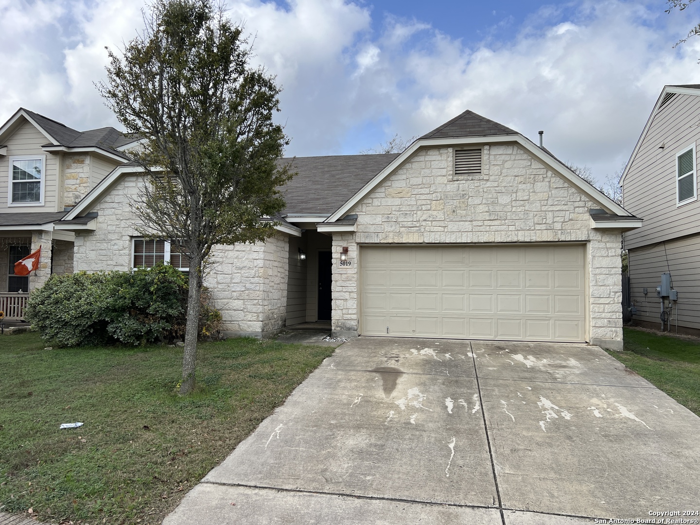 a front view of a house with a yard and garage