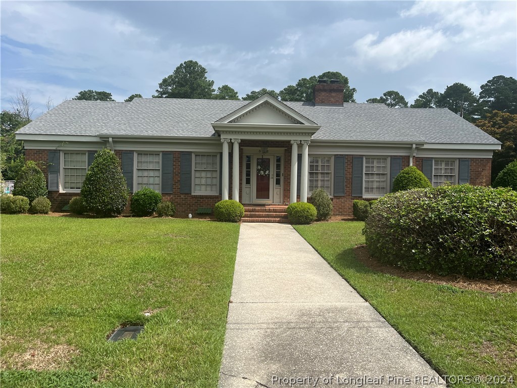 a front view of a house with garden