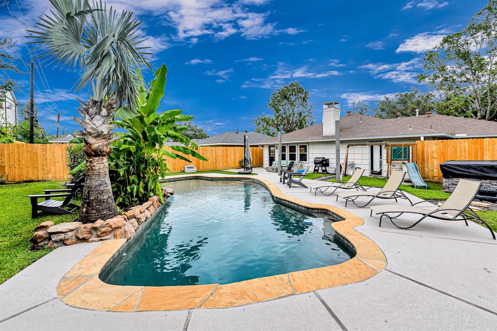 a view of a swimming pool with a patio