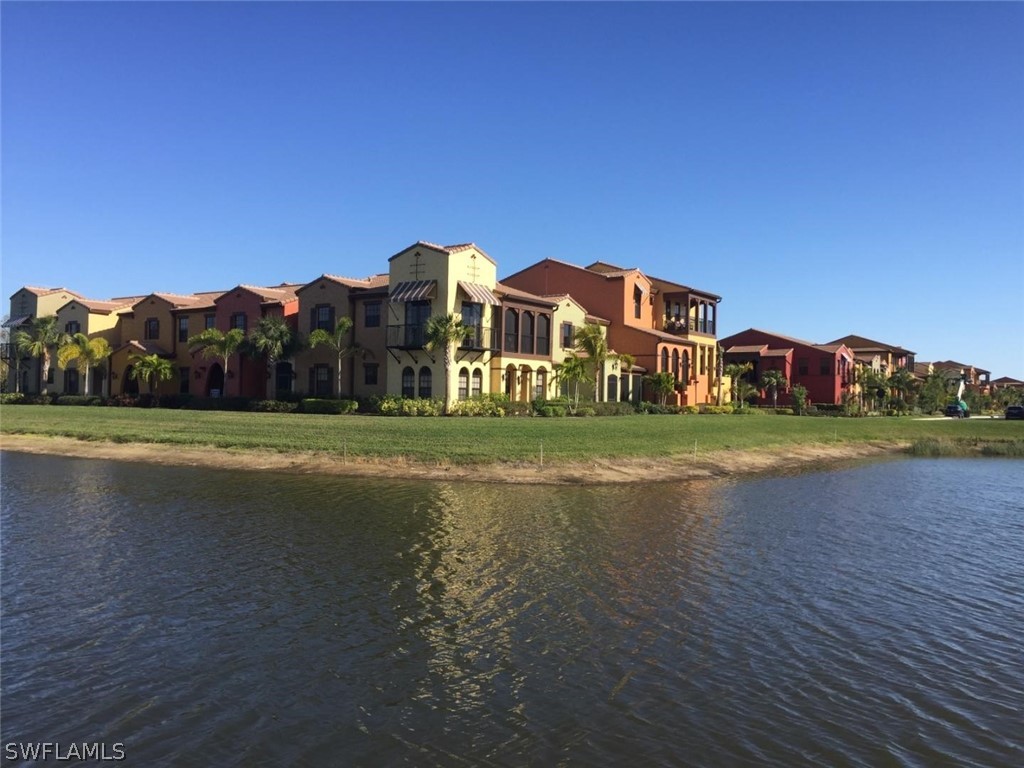 a view of building with river in front of it