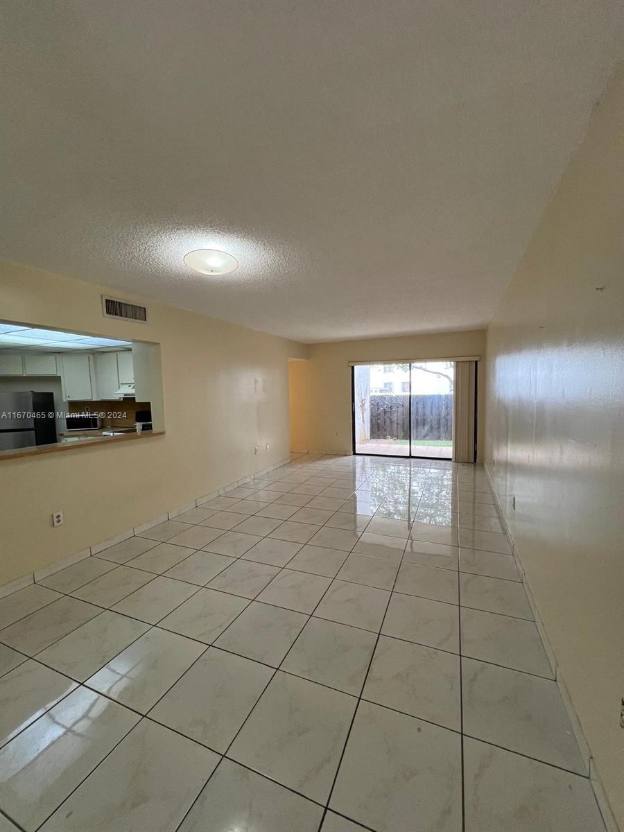 a view of a kitchen with an empty space and window