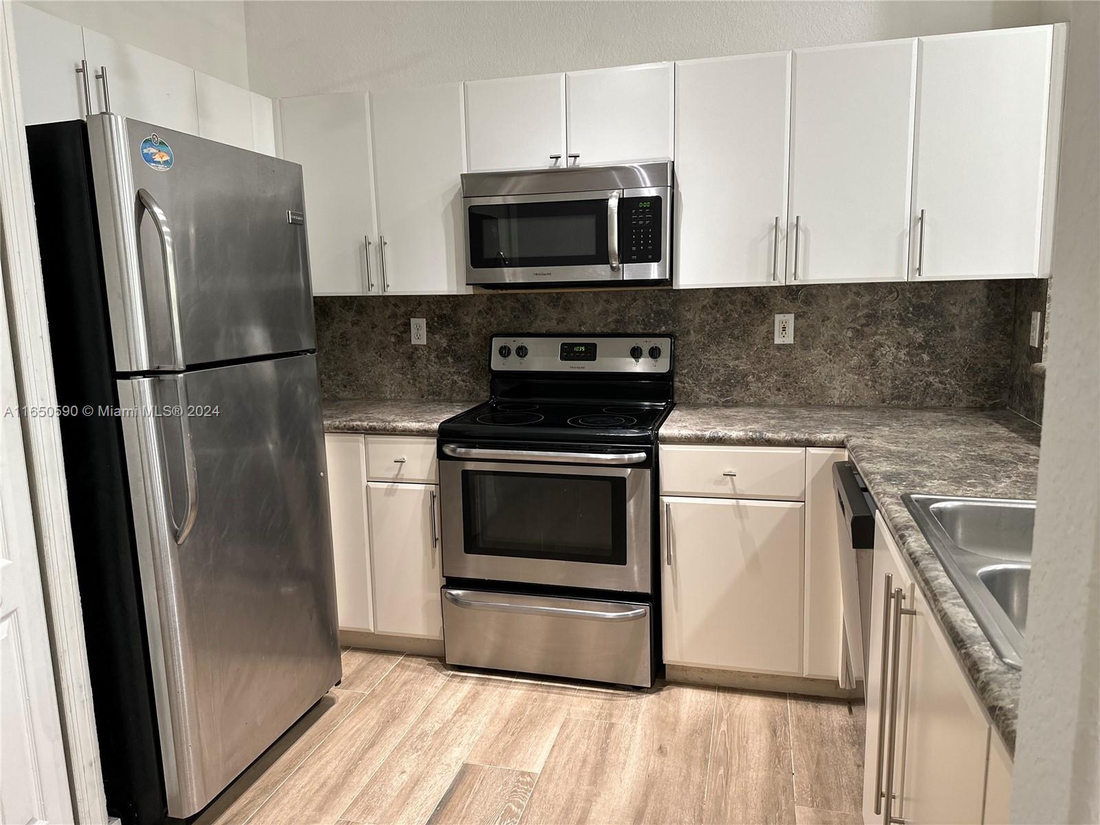 a kitchen with a stove microwave and refrigerator