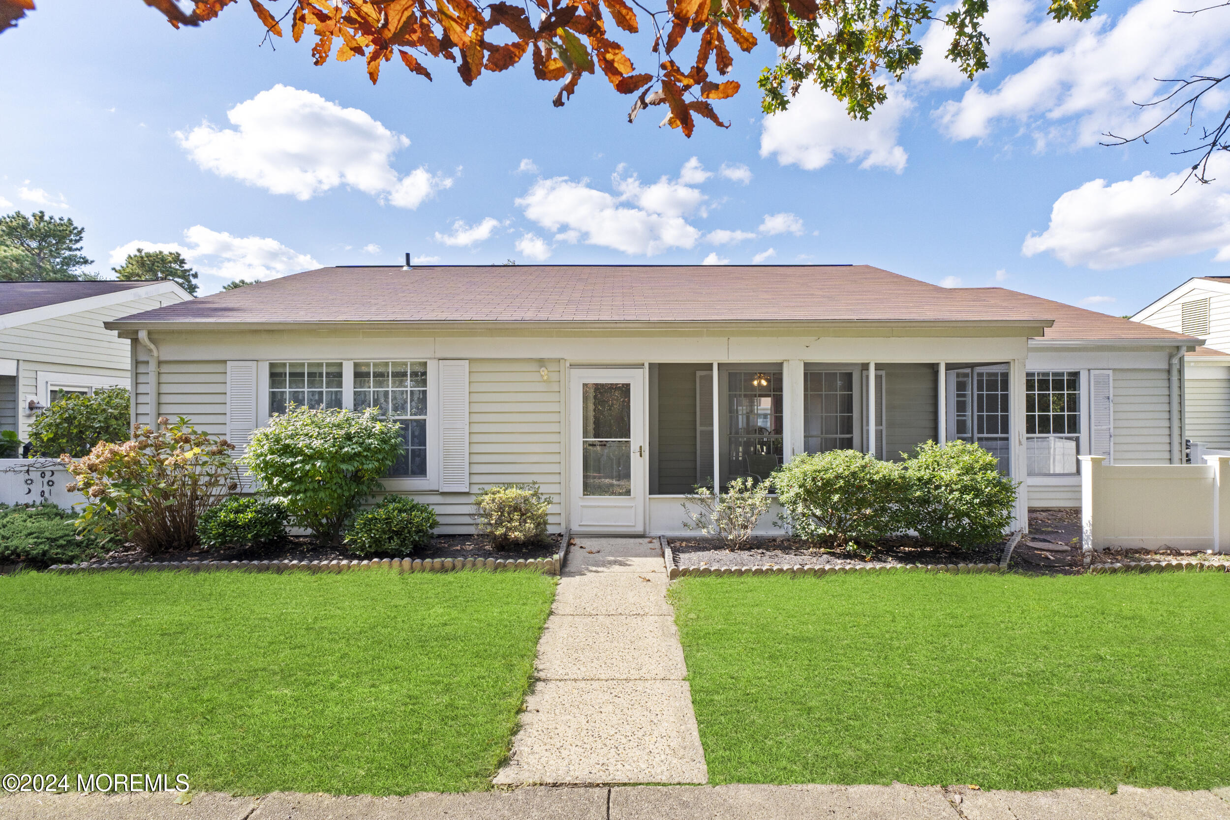 a front view of a house with garden and porch