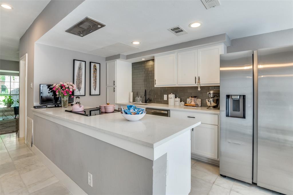 a kitchen with refrigerator and flowers