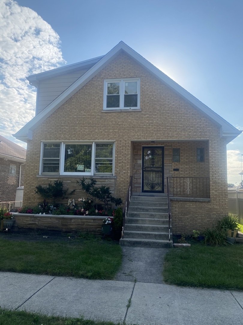 a front view of a house with a garden