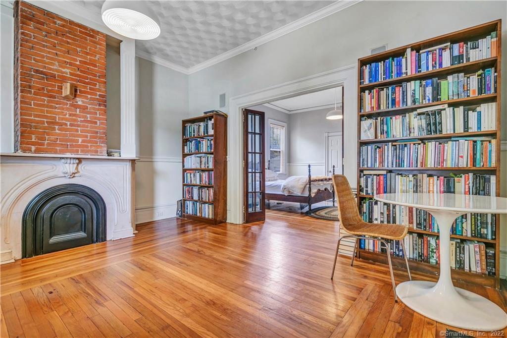 a spacious bedroom with a bed and a book shelf