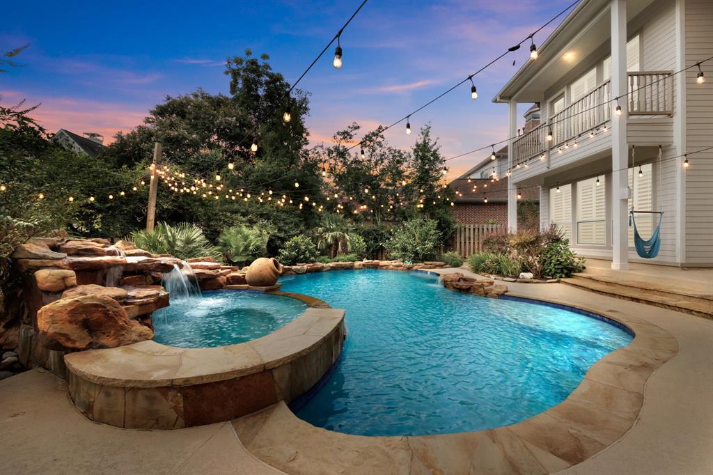 a view of a house with swimming pool and sitting area