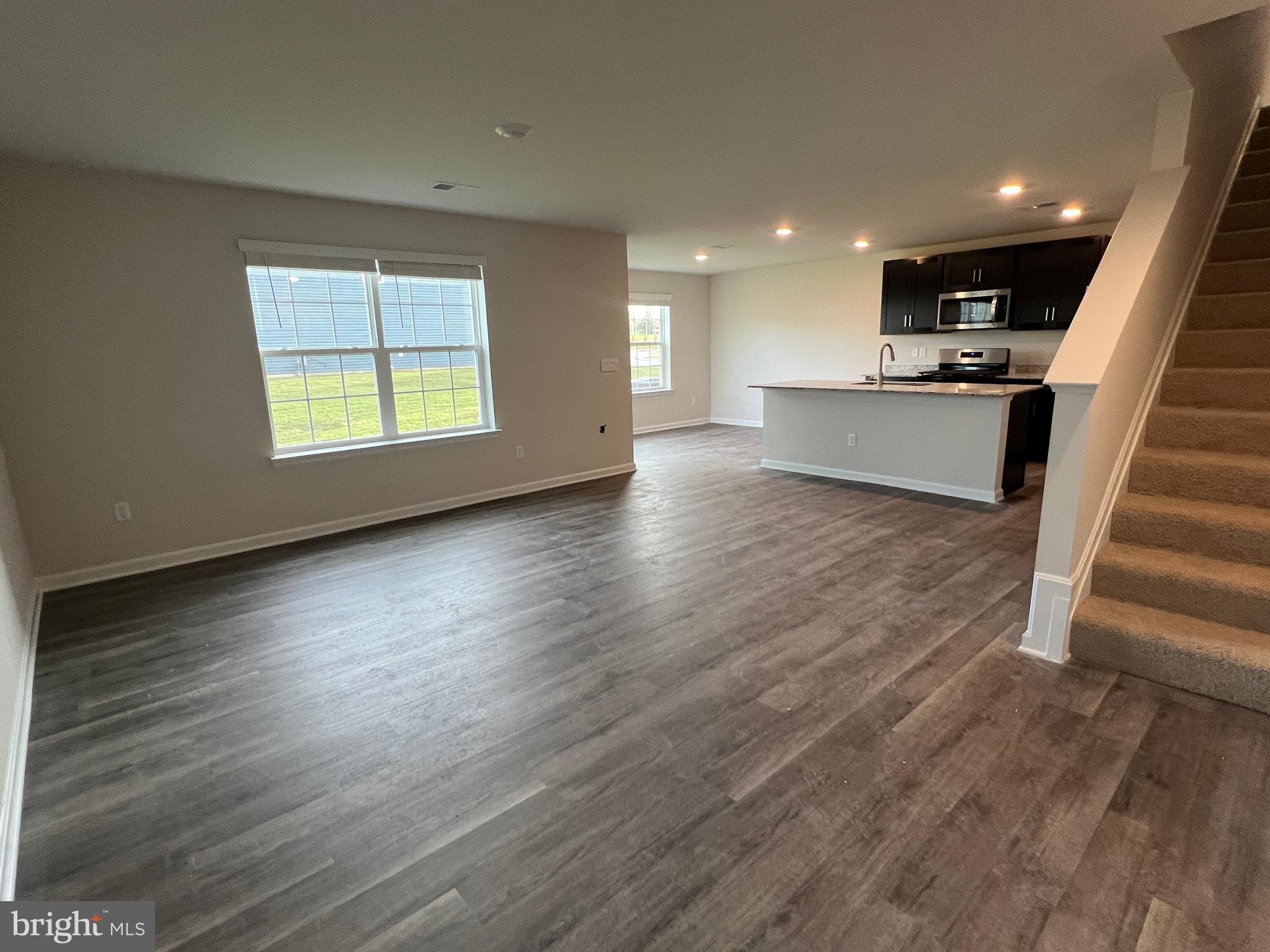 a view of kitchen with wooden floor and electronic appliances