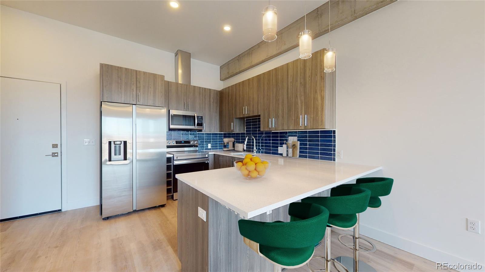 a kitchen with stainless steel appliances a stove a sink and a refrigerator