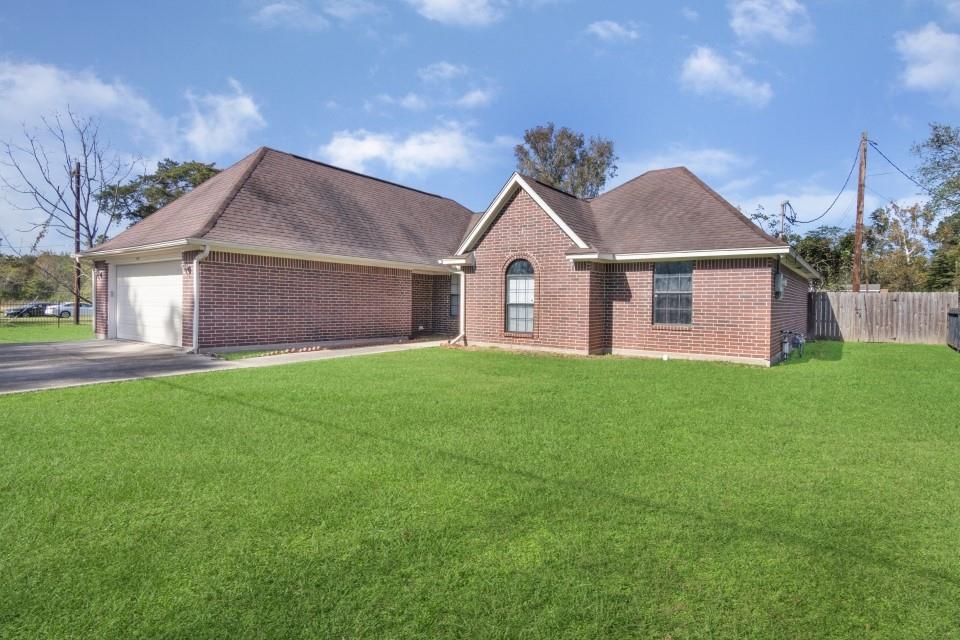 a front view of a house with a garden and yard