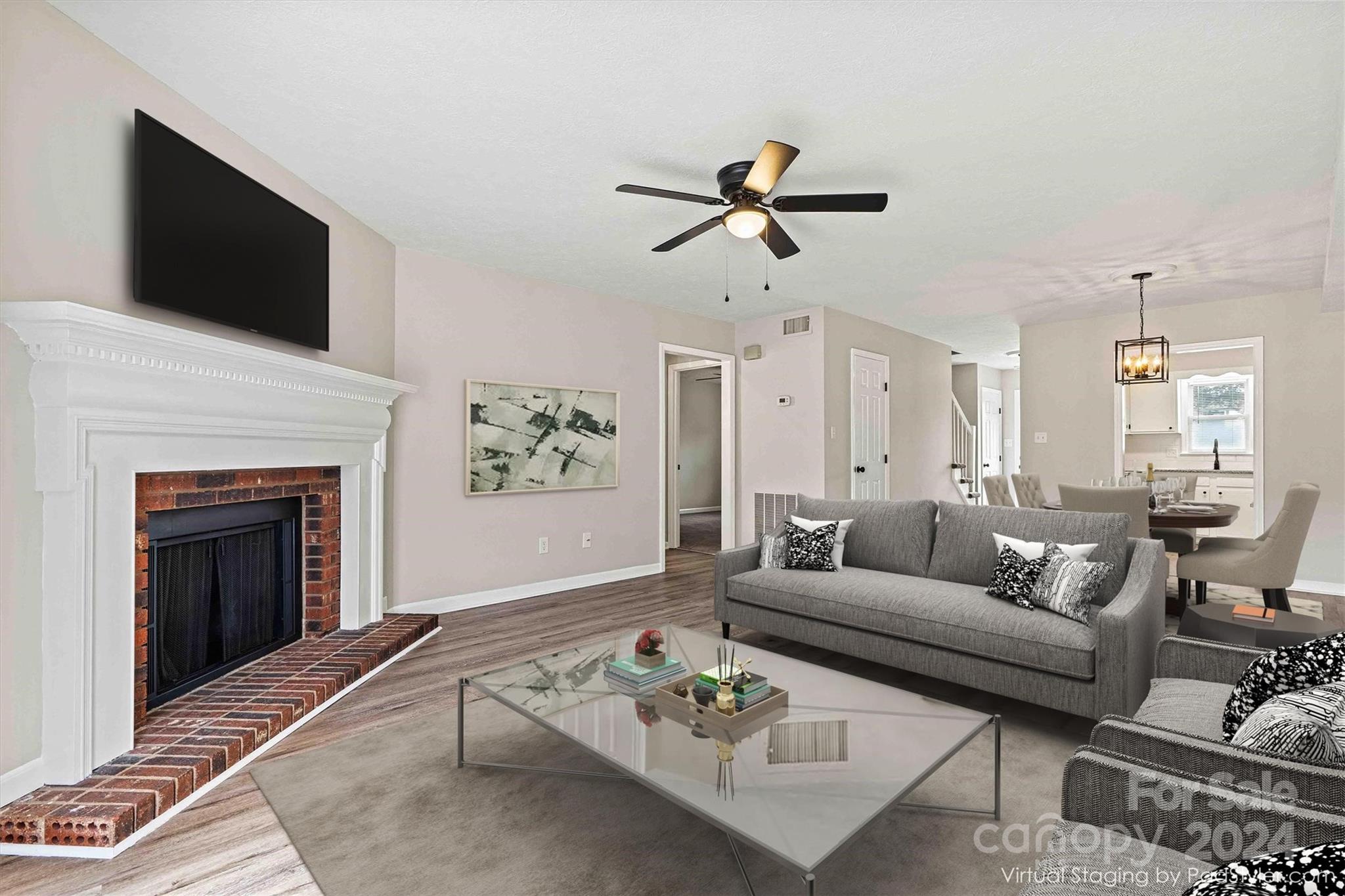 a living room with furniture a fireplace and a flat screen tv