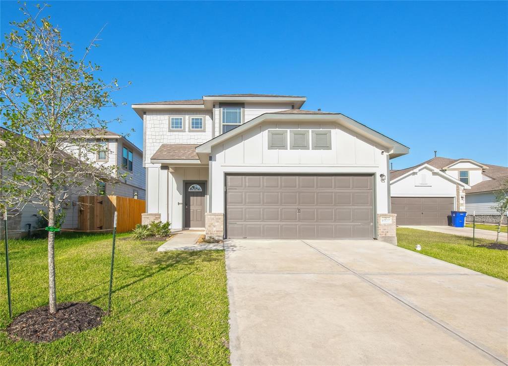 a front view of a house with a yard and garage