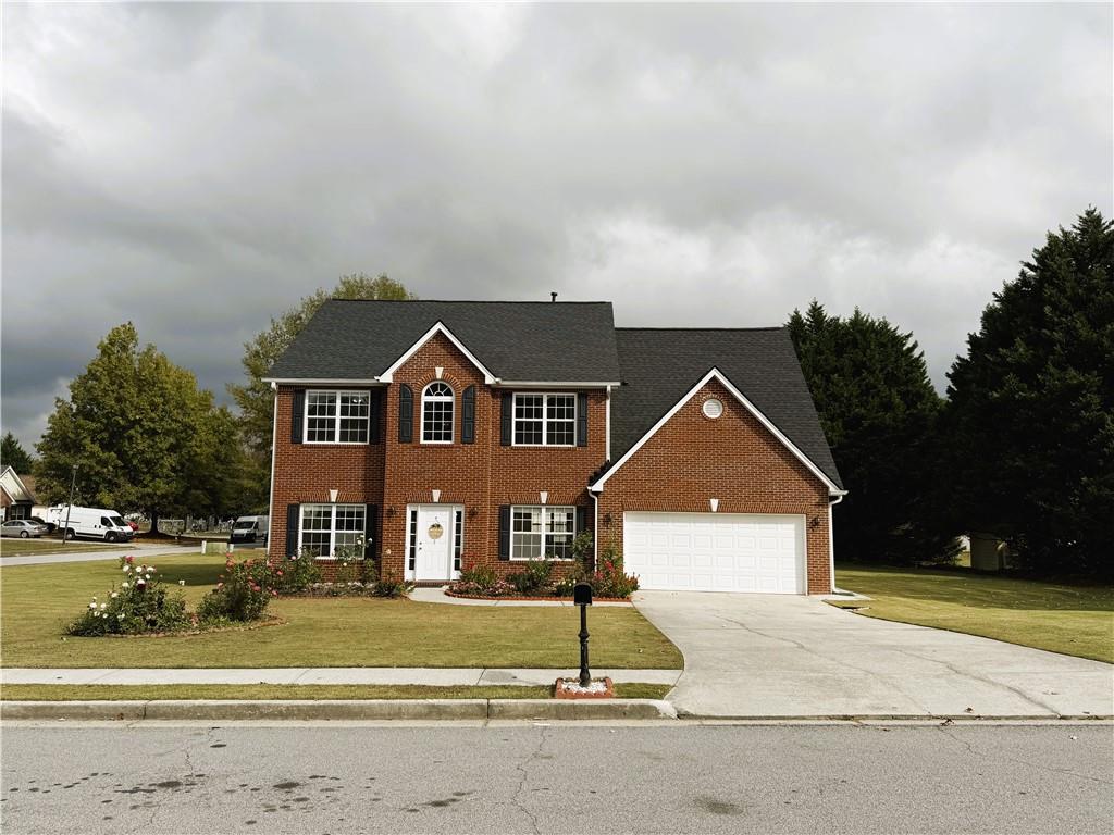 a front view of a house with a yard and garage