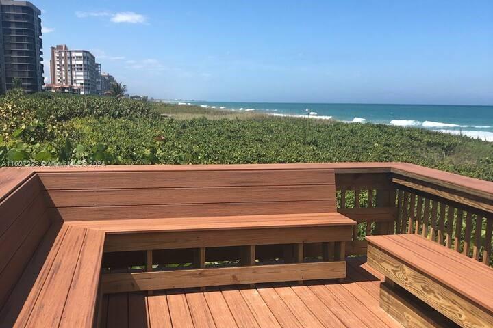 a view of balcony with wooden floor and a yard