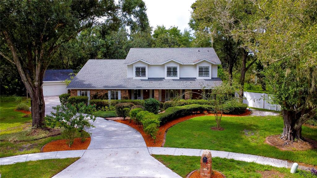 a view of a house with garden and yard