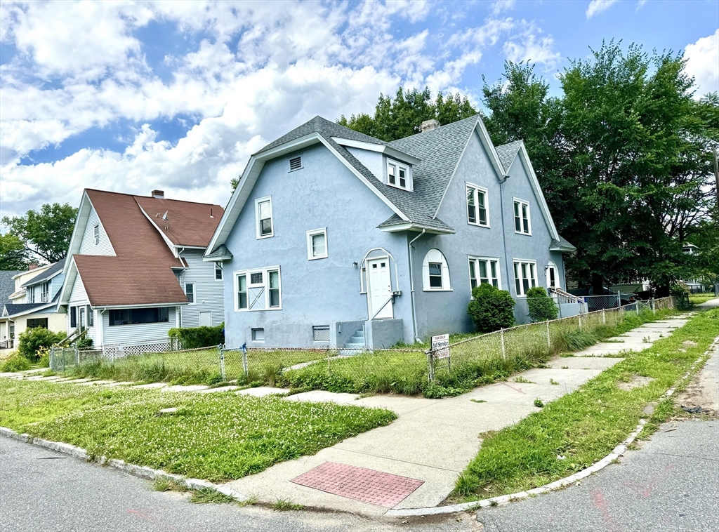 a front view of house with yard and green space