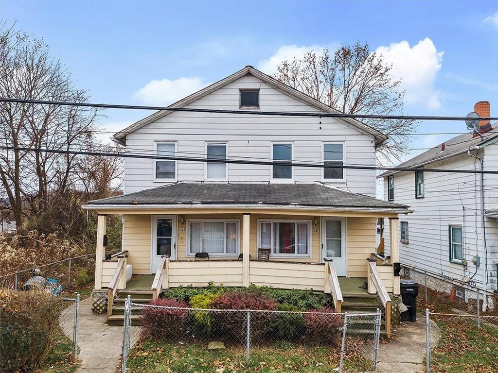 a front view of a house with garden and patio