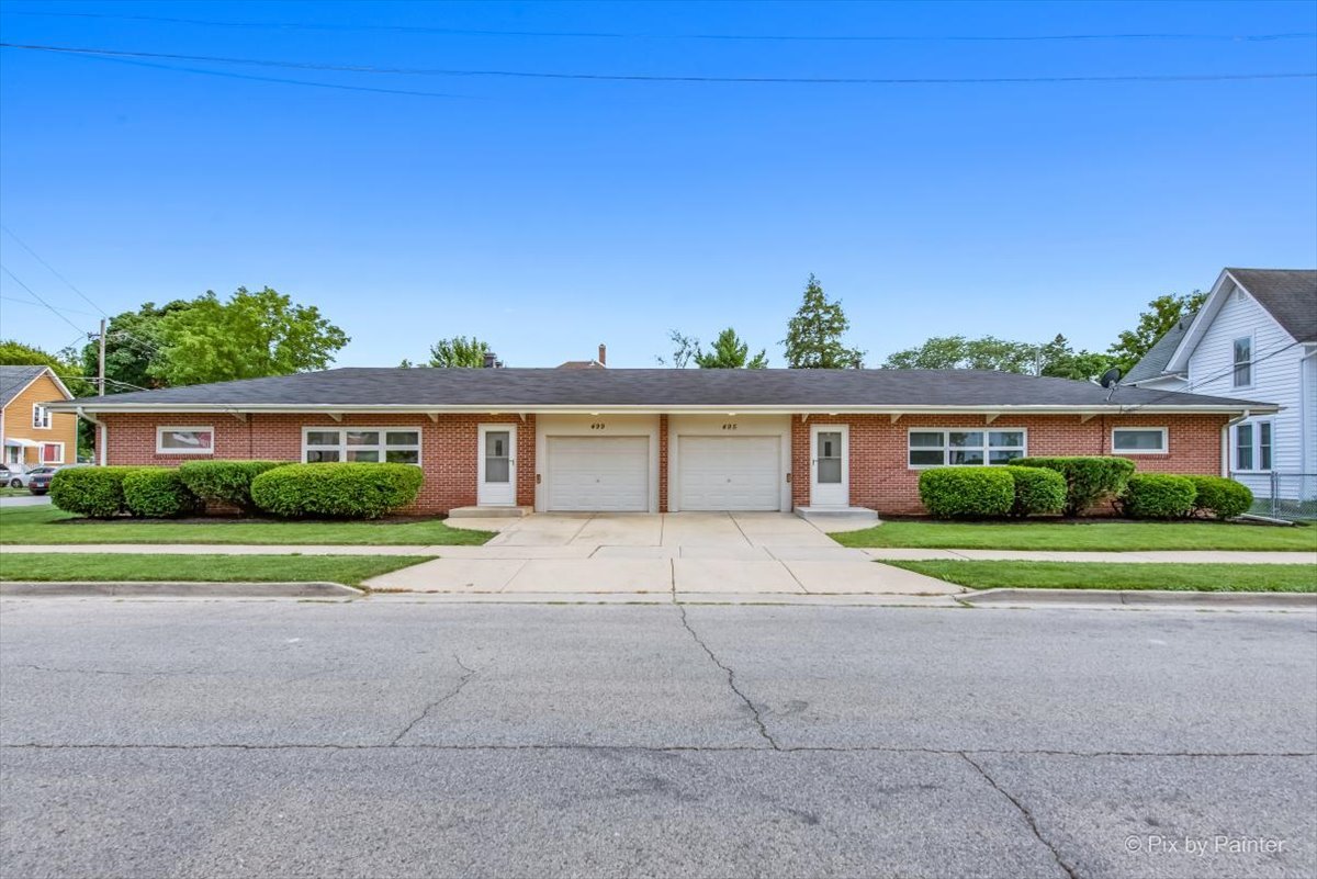 a front view of house with outdoor space and street view