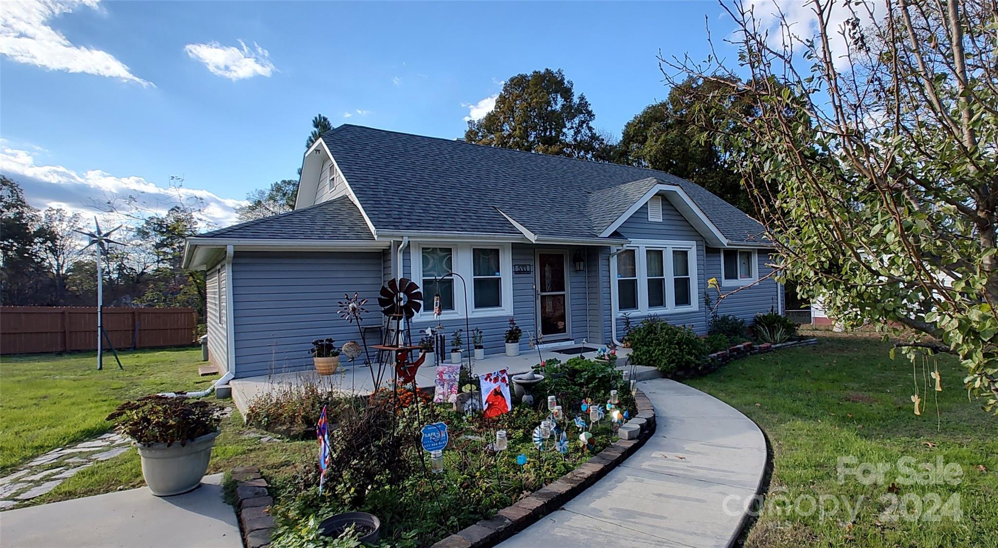 a view of a house with a yard and garden