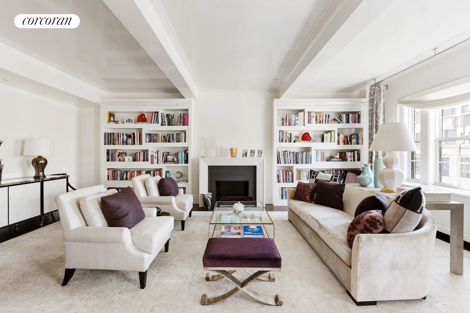 a living room with furniture a rug and a bookshelf