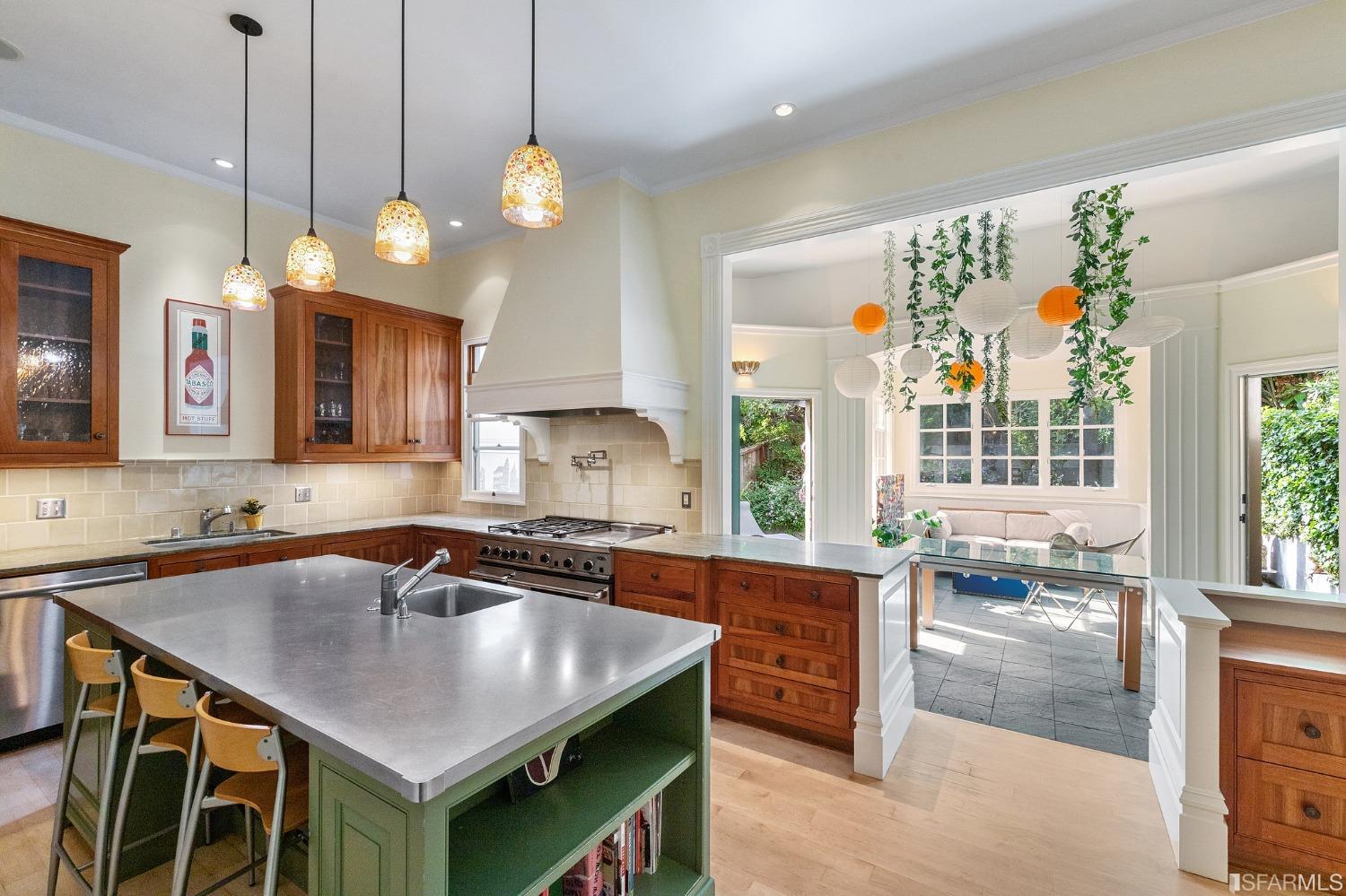 a kitchen with a table a sink and cabinets